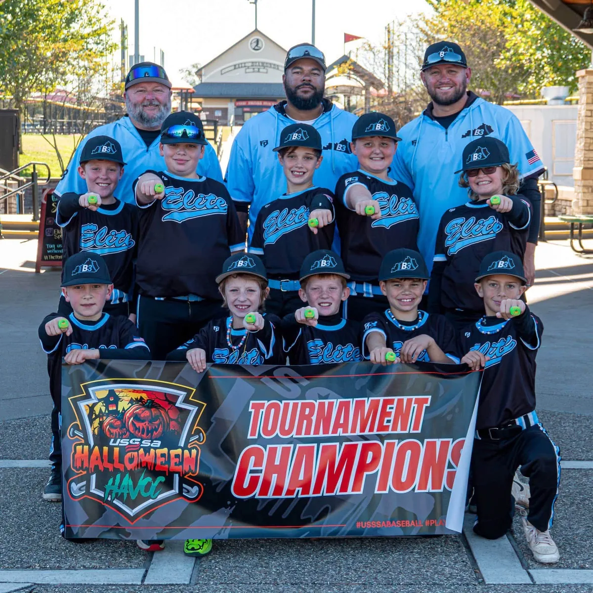 B3 Elite 10U players and coaches holding the USSSA Halloween Havoc Tournament Champions banner, October 2026